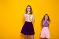 Two girls shut mouth finger silence Royalty Free Stock Photo