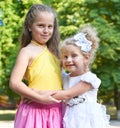 Two girls sister portrait, childhood concept, happy child posing in city park Royalty Free Stock Photo