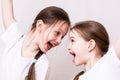 Two girls sisters emotionally smile at each other