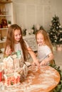 Two girls sisters are playing around in the kitchen after making Christmas cookies Royalty Free Stock Photo
