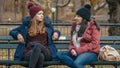 Two girls sit on a bench on Central Park enjoying their time in New York Royalty Free Stock Photo