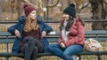 Two girls sit on a bench on Central Park enjoying their time in New York Royalty Free Stock Photo