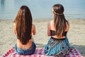 Two girls sitting on the beach and watching the sea Royalty Free Stock Photo