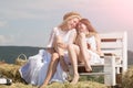 Two girls sitting on bench on hay Royalty Free Stock Photo