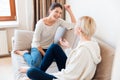 Two girls sitting on the sofa and gossiping Royalty Free Stock Photo