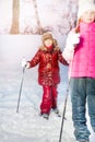 Two girls skiing in the white winter forest Royalty Free Stock Photo