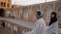 Two girls with a smile posing in a mosque in Kashan