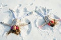 Two Girls on a snow angel shows. Children playing and making a snow angel in the snow. Top view. Royalty Free Stock Photo