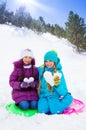 Two girls with snow hearts Royalty Free Stock Photo