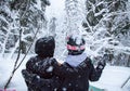 Two girls with a snowboards in the forest in the mountains and the snowfall