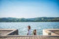 Two girls standing on river dock and looking sideways Royalty Free Stock Photo