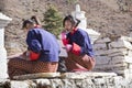 Two girls studying in front of the entrance to the Rinpung Dzong in Paro, Bhutan