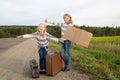 Two girls with suitcase standing about road Royalty Free Stock Photo