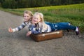 Two girls with suitcase standing about road Royalty Free Stock Photo