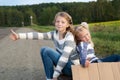 Two girls with suitcase standing about road Royalty Free Stock Photo