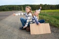 Two girls with suitcase standing about road Royalty Free Stock Photo