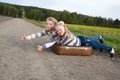 Two girls with suitcase standing about road Royalty Free Stock Photo