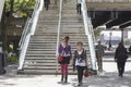 Two girls in sunglasses descend the stairs from the bridge on the South Bank Thames embankment Royalty Free Stock Photo