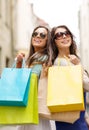 Two girls in sunglasses with shopping bags in ctiy Royalty Free Stock Photo