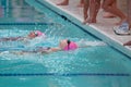 Two Girls Swimming Backstroke Reach For Wall
