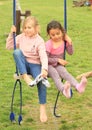 Two girls on swing