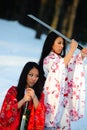 Two girls about a sword in hands Royalty Free Stock Photo