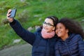 Two girls taking a photo with the mobile Royalty Free Stock Photo