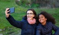 Two girls taking a photo with the mobile Royalty Free Stock Photo