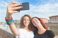 Two girls taking a selfie in the city Royalty Free Stock Photo
