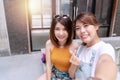 Two girls taking selfie photograph photo. Cheerful two young Asian women taking photo together with felling happiness while