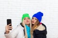 Two girls taking selfie picture with duck face lips emotion women friends posing smart phone photo Royalty Free Stock Photo