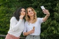 Two girls are taking selfies and eating ice cream