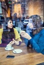 Two girls talking in a cafe Royalty Free Stock Photo