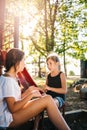 Two girls talking on a playground in summer Royalty Free Stock Photo