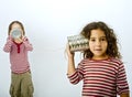 Two girls talking on a tin phone Royalty Free Stock Photo