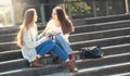 Two Girls Talking Together in the Street Royalty Free Stock Photo