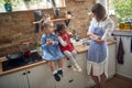 Two Girls and Their Smiling Mother Share Muffins in the Kitchen Royalty Free Stock Photo