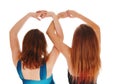 Two girls with there hands up.