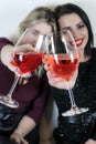 Two girls toasting to celebrate an event, focus on the glasses Royalty Free Stock Photo