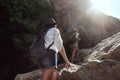 Two girls of a tourist`s girlfriend climb the mountains, help each other, reach out a helping hand. Royalty Free Stock Photo