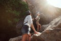 Two girls of a tourist`s girlfriend climb the mountains, help each other, reach out a helping hand. Royalty Free Stock Photo