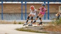 Two girls training in speed skating on rollerdrome