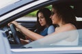 two girls travel the roads in a car, look at the map Vacation concept Royalty Free Stock Photo