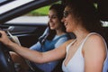 two girls travel the roads in a car, look at the map Vacation concept Royalty Free Stock Photo