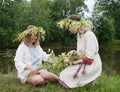 Two girls is twist flowers into a wreath Royalty Free Stock Photo