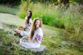 Two girls in Ukrainian shirts are on the background of the river Royalty Free Stock Photo