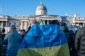 Two girls with a Ukranian flag in front of the National Gallery at an anti war protest in London