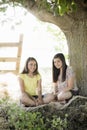 Two Girls Under a Tree