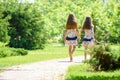 Two girls walk along a path in a beautiful city park