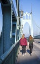 Two girls walk along the sidewalk on St Jones Bridge